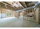 Unfinished basement featuring exposed wooden framing and a bright window bringing in natural light at 130 Lapis Lake Pt, Fayetteville, GA 30215