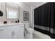 Modern bathroom featuring a sleek vanity with elegant fixtures and a shower with stylish curtain at 130 Lapis Lake Pt, Fayetteville, GA 30215