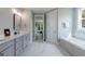 Spacious bathroom with double vanity, soaking tub, and modern finishes at 130 Lapis Lake Pt, Fayetteville, GA 30215