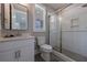 Modern bathroom with a sleek vanity, toilet, and a glass-enclosed shower at 130 Lapis Lake Pt, Fayetteville, GA 30215