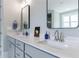 Stylish bathroom featuring double sinks with modern fixtures and sleek gray cabinetry at 130 Lapis Lake Pt, Fayetteville, GA 30215