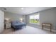 Bright bedroom featuring neutral walls, carpet and a large window with a nice view at 130 Lapis Lake Pt, Fayetteville, GA 30215