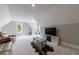 Large bonus room featuring neutral walls, carpet, a large window and fireplace at 130 Lapis Lake Pt, Fayetteville, GA 30215