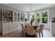 Formal dining area with a round wood table, seating for four, and a view to the tree-lined yard at 130 Lapis Lake Pt, Fayetteville, GA 30215