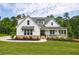 Charming two-story white farmhouse with covered front porch at 130 Lapis Lake Pt, Fayetteville, GA 30215