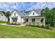 Attractive two-story home featuring a welcoming covered porch at 130 Lapis Lake Pt, Fayetteville, GA 30215