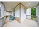 Relaxing covered porch with chairs and scenic views at 130 Lapis Lake Pt, Fayetteville, GA 30215