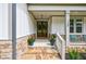Inviting front porch with stone steps and double doors at 130 Lapis Lake Pt, Fayetteville, GA 30215