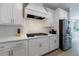 This kitchen has stainless steel appliances, stylish backsplash, and a modern white color scheme at 130 Lapis Lake Pt, Fayetteville, GA 30215