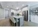 Kitchen with a large island, stainless steel appliances, white cabinetry, and an eat-in countertop at 130 Lapis Lake Pt, Fayetteville, GA 30215