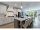 Bright kitchen with a large island, pendant lights, stainless steel appliances, and an open floor plan at 130 Lapis Lake Pt, Fayetteville, GA 30215
