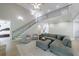 Bright living room featuring a vaulted ceiling, a gray sectional, a staircase, and views to the upstairs at 130 Lapis Lake Pt, Fayetteville, GA 30215