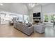 Bright living room with high ceilings, a stone fireplace, hardwood floors, and an open floor plan at 130 Lapis Lake Pt, Fayetteville, GA 30215