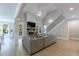 Open-concept living room with vaulted ceilings, stone fireplace, hardwood floors, and staircase with iron railing at 130 Lapis Lake Pt, Fayetteville, GA 30215