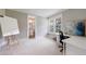 Home office featuring natural light, desk space, and an adjacent bathroom at 130 Lapis Lake Pt, Fayetteville, GA 30215