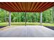 Covered patio with exposed wood beams, perfect for outdoor relaxation and enjoying nature at 130 Lapis Lake Pt, Fayetteville, GA 30215