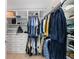 Spacious walk-in closet with custom shelving, drawers, and hanging rods for optimal storage at 130 Lapis Lake Pt, Fayetteville, GA 30215
