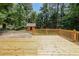 Wooden deck surrounded by mature trees and leads to a storage shed in backyard at 213 Linda Dr, Tucker, GA 30084