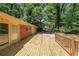 Spacious wooden deck offers serene views of the backyard and surrounding trees at 213 Linda Dr, Tucker, GA 30084