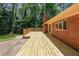 Spacious deck with wood railing adjoins the brick house at 213 Linda Dr, Tucker, GA 30084
