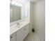 Well-lit bathroom offering a large mirror, vanity and white tiled floors at 213 Linda Dr, Tucker, GA 30084