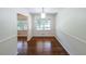Bright dining room featuring gleaming hardwood floors and natural light from the window at 213 Linda Dr, Tucker, GA 30084