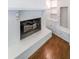Cozy white painted fireplace with built-in shelves and hardwood floors at 213 Linda Dr, Tucker, GA 30084