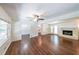 Open concept living room with hardwood floors, fireplace, and ample natural light at 213 Linda Dr, Tucker, GA 30084
