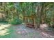 Picturesque outdoor seating area featuring a rustic wooden picnic table beneath a vine-covered arbor at 213 Linda Dr, Tucker, GA 30084