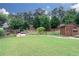 Expansive backyard features a wooden shed, stone path, and a lush garden, creating a perfect outdoor escape at 2256 Long Bow Chase Nw, Kennesaw, GA 30144