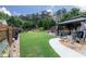 Expansive backyard with a well-manicured lawn, landscaped beds, and outdoor seating beneath a stylish gazebo at 2256 Long Bow Chase Nw, Kennesaw, GA 30144
