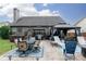 Outdoor patio area with a large gazebo, hot tub, dining set, and lounge chairs, ideal for entertaining and relaxation at 2256 Long Bow Chase Nw, Kennesaw, GA 30144