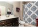 Bathroom with dark wood vanity, white countertop, patterned shower curtain, providing a clean and functional space at 2256 Long Bow Chase Nw, Kennesaw, GA 30144