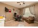 Cozy bedroom with ceiling fan, chair, desk, and wall-mounted TV, perfect for relaxing or working from home at 2256 Long Bow Chase Nw, Kennesaw, GA 30144