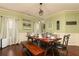 Cozy dining room featuring hardwood floors, light green walls, and a view into the living room, perfect for entertaining at 2256 Long Bow Chase Nw, Kennesaw, GA 30144
