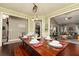 Cozy dining room featuring hardwood floors, light green walls, and a view into the living room, perfect for entertaining at 2256 Long Bow Chase Nw, Kennesaw, GA 30144