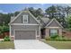 Charming Craftsman-style home with a well-maintained lawn, gray siding, brick accents, and an attached two-car garage at 2256 Long Bow Chase Nw, Kennesaw, GA 30144