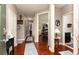 Long hallway with hardwood floors and neutral walls leading to multiple rooms, creating an open and airy feel at 2256 Long Bow Chase Nw, Kennesaw, GA 30144