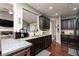 Kitchen view features dark cabinets, granite countertops, stainless appliances, and hardwood floors at 2256 Long Bow Chase Nw, Kennesaw, GA 30144