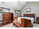 Relax in this main bedroom featuring wood floors, a king bed, and a barn door to ensuite bath at 2256 Long Bow Chase Nw, Kennesaw, GA 30144