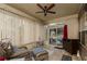 Cozy sun room features lots of light, ceiling fan, and furniture for relaxation at 2256 Long Bow Chase Nw, Kennesaw, GA 30144