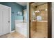 Stylish bathroom featuring a soaking tub, a separate glass-enclosed shower, and neutral tile at 3491 Amerigo Dr, Buford, GA 30519