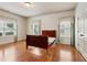Bedroom with three windows and a walk-in closet, featuring hardwood floors at 3491 Amerigo Dr, Buford, GA 30519