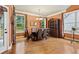 Dining room featuring hardwood floors, large windows, and a decorative cabinet at 3491 Amerigo Dr, Buford, GA 30519