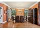 Dining room with hardwood floors, large windows, chandelier, and decorative cabinet at 3491 Amerigo Dr, Buford, GA 30519