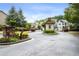 Gated community entrance with well-maintained landscaping and a charming guard house at 3491 Amerigo Dr, Buford, GA 30519
