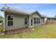 Back of home featuring an enclosed sunroom and landscaped yard at 3491 Amerigo Dr, Buford, GA 30519