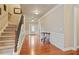 Inviting foyer with hardwood floors, a staircase, and classic wainscoting, leading to the main living areas at 3491 Amerigo Dr, Buford, GA 30519