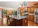 Spacious kitchen featuring a large island, stainless steel appliances, and open access to the dining area at 3491 Amerigo Dr, Buford, GA 30519