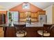 Modern kitchen with granite countertops, stainless steel appliances, and ample cabinet space under a vaulted ceiling at 3491 Amerigo Dr, Buford, GA 30519